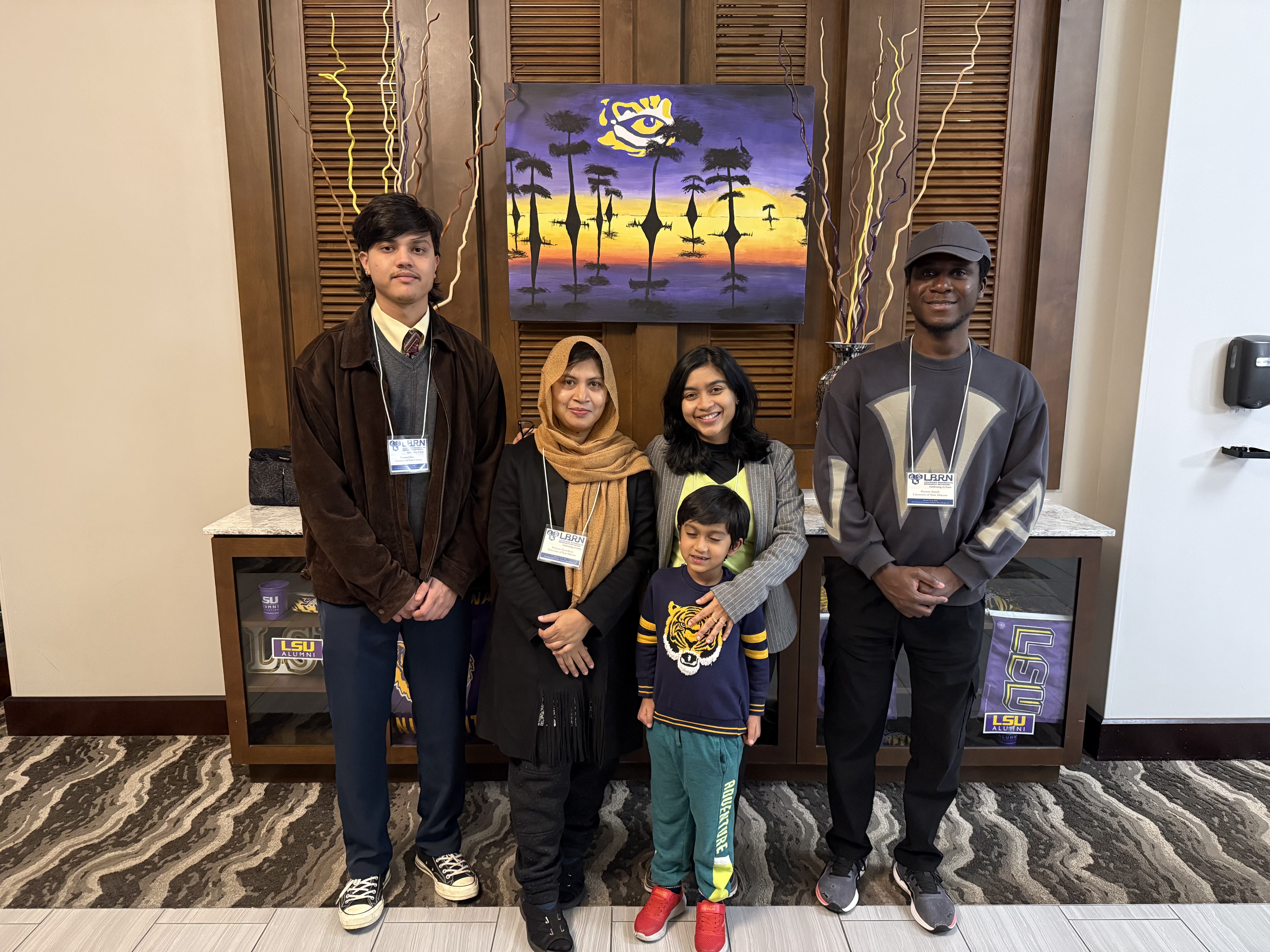 Pranish Ghimire with lab team members at an LBRN conference presentation