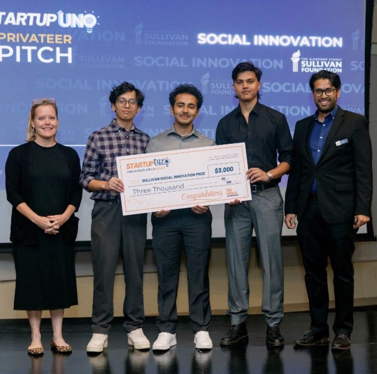 Pranish Ghimire and the SensorySync team holding the StartupUNO Social Innovation prize check
